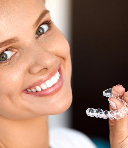 Woman holding an Invisalign 